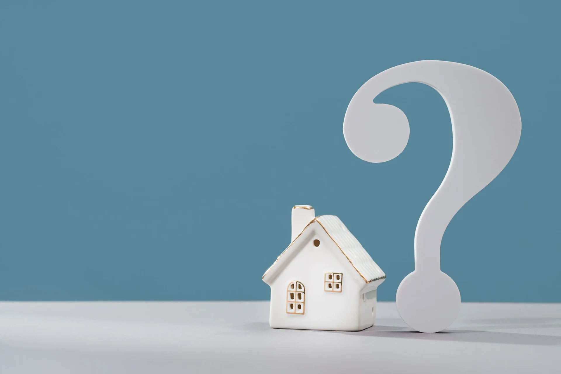 Model home beside a question mark