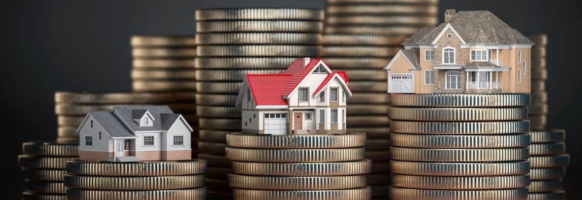Model houses on stacks of coins