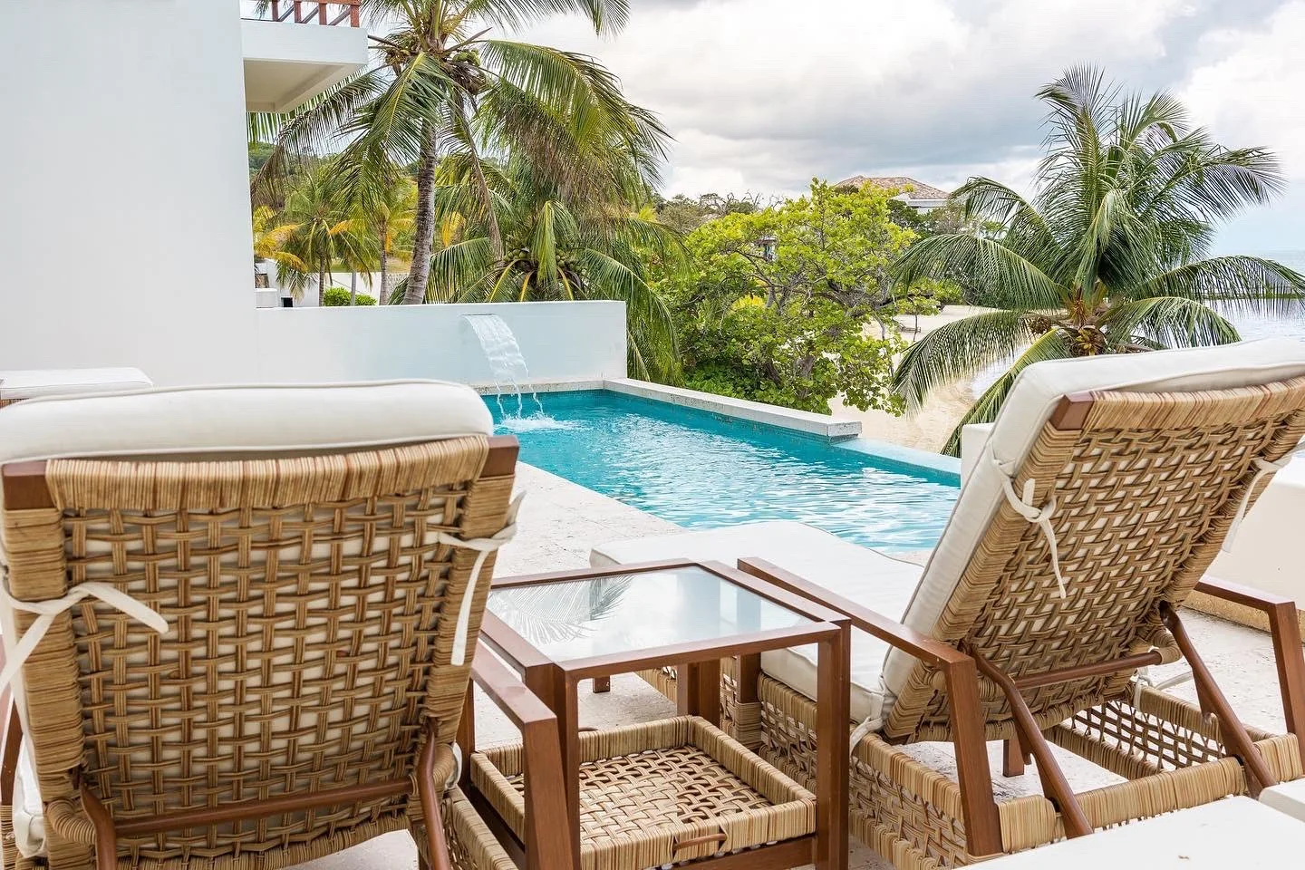 Outdoor seating beside a swimming pool