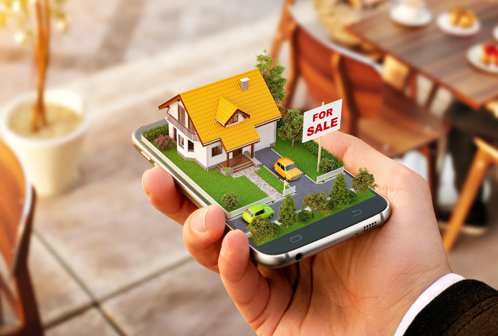 Person holding a model house